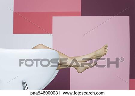 Woman reclining on armchair, cropped view of bare legs View Large Photo Image Stock Image - Woman reclining on armchair, cropped view of bare legs. Fotosearch