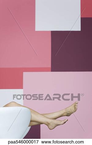 Woman reclining on armchair, cropped view of bare legs View Large Photo Image Stock Photo - Woman reclining on armchair, cropped view of bare legs. Fotosearch