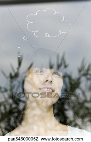 Stock Image - Young woman with thought bubble over head. Fotosearch