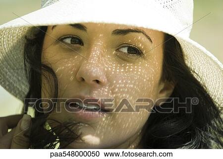"Young brunette woman wearing sunhat, close-up" View Large Photo Image Stock Image - "Young brunette woman wearing sunhat, close-up". Fotosearch