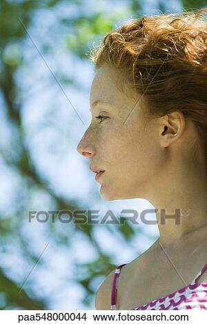 "Young red haired woman in profile, portrait" View Large Photo Image Picture - "Young red haired woman in profile, portrait". Fotosearch