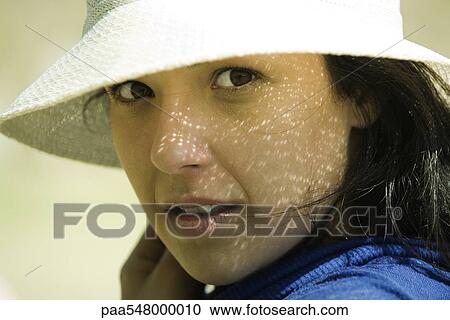 Young woman in sun hat looking over shoulder at camera View Large Photo Image Stock Image - Young woman in sun hat looking over shoulder at camera. Fotosearch
