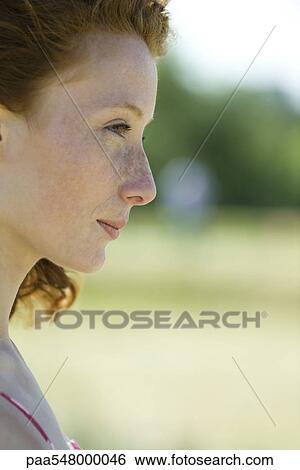 "Young woman outdoors, looking away, profile" View Large Photo Image Stock Photograph - "Young woman outdoors, looking away, profile". Fotosearch