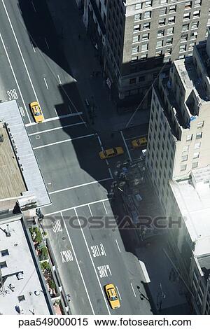 Aerial view of taxis on street lined with high rise buildings View Large Photo Image Stock Photography - Aerial view of taxis on street lined with high rise buildings. Fotosearch