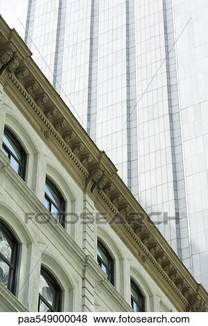 "Facade of neoclassical building, modern skyscraper towering above, low angle view" View Large Photo Image Stock Photo - "Facade of neoclassical building, modern skyscraper towering above, low angle view". Fotosearch