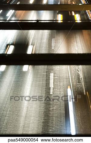 "Headlights of oncoming traffic speeding along freeway, high angle view" View Large Photo Image Picture - "Headlights of oncoming traffic speeding along freeway, high angle view". Fotosearch
