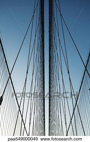 "Iron support wires of suspension bridge against blue sky, low angle view" View Large Photo Image Stock Photo - "Iron support wires of suspension bridge against blue sky, low angle view". Fotosearch