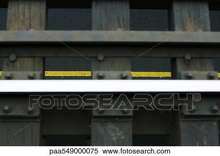"Rails, wooden girders of elevated railway, yellow lines of street below visible in background" View Large Photo Image Stock Photography - "Rails, wooden girders of elevated railway, yellow lines of street below visible in background". Fotosearch