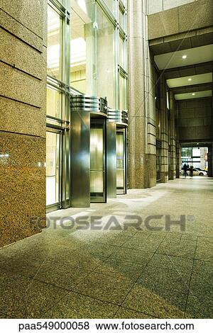 Revolving doors at high rise building entrance View Large Photo Image Stock Photo - Revolving doors at high rise building entrance. Fotosearch