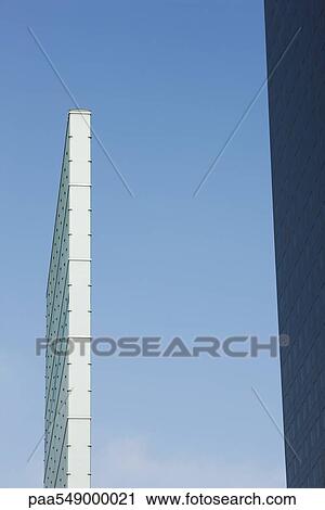"Sculpture near high rise office building, low angle view" View Large Photo Image Stock Image - "Sculpture near high rise office building, low angle view". Fotosearch