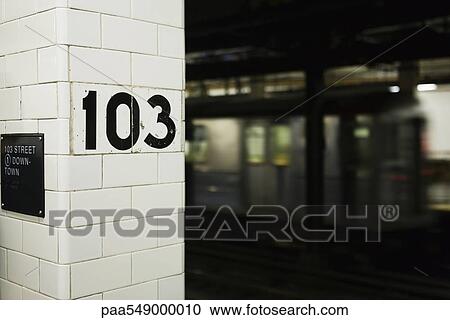 "Sign on column on subway platform, subway leaving station" View Large Photo Image Stock Image - "Sign on column on subway platform, subway leaving station". Fotosearch