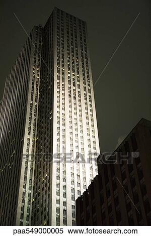 Skyscraper spot lit at night View Large Photo Image Stock Photography - Skyscraper spot lit at night. Fotosearch