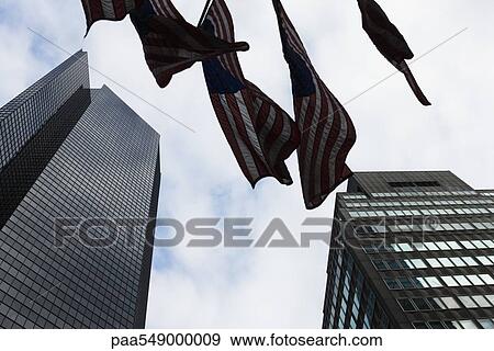 "Skyscrapers, flags waiving in breeze, viewed from below" View Large Photo Image Stock Photo - "Skyscrapers, flags waiving in breeze, viewed from below". Fotosearch