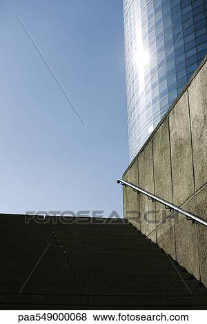 "Stairs leading up from subway entrance, high risde building in background, low angle view" View Large Photo Image Stock Photo - "Stairs leading up from subway entrance, high risde building in background, low angle view". Fotosearch