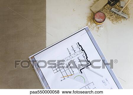 Stock Photo - Blueprint spread out on floor. Fotosearch
