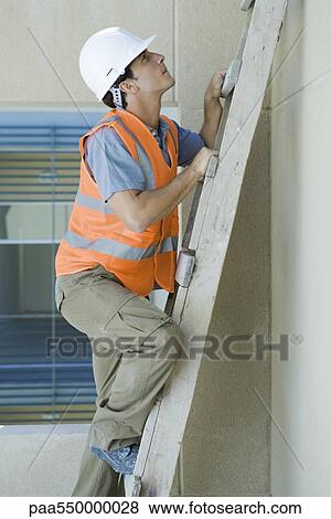 Stock Photo - Construction worker climbing ladder. Fotosearch