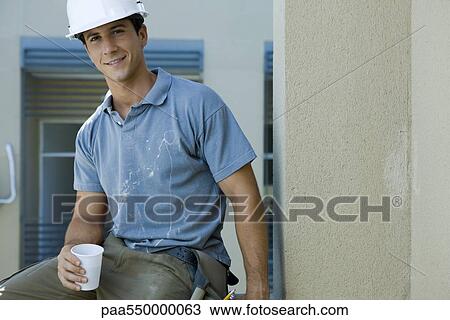 "Construction worker holding disposable cup, taking break" View Large Photo Image Stock Image - "Construction worker holding disposable cup, taking break". Fotosearch