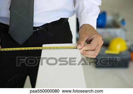 "Well-dressed person measuring ledge width, close-up" View Large Photo Image Stock Image - "Well-dressed person measuring ledge width, close-up". Fotosearch