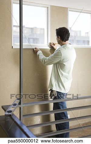 Worker measuring windowsill with ruler View Large Photo Image Stock Image - Worker measuring windowsill with ruler. Fotosearch