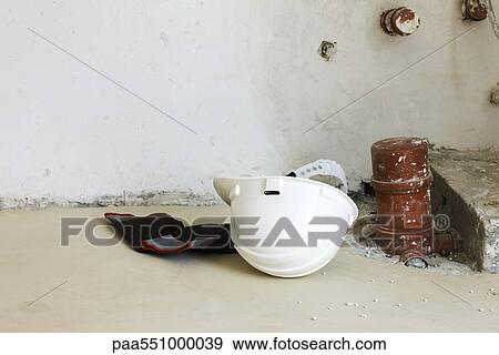 "Gloves, hard hat on floor near plumbing fixture" View Large Photo Image Stock Photo - "Gloves, hard hat on floor near plumbing fixture". Fotosearch