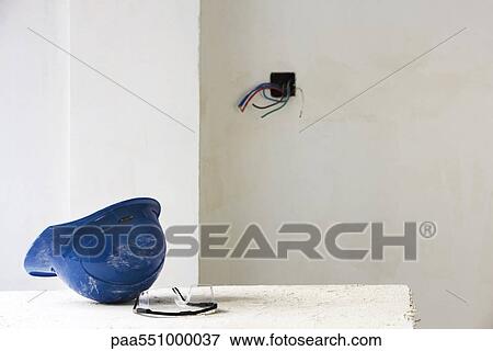 Hard hat on table in unfinished room View Large Photo Image Stock Photo - Hard hat on table in unfinished room. Fotosearch