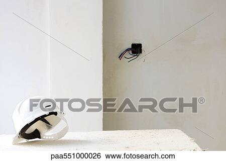 Hard hat on table in unfinished room View Large Photo Image Stock Photograph - Hard hat on table in unfinished room. Fotosearch