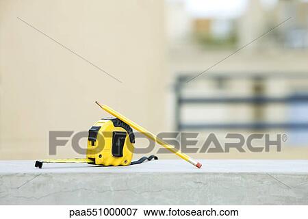 Measuring tape with pencil on ledge View Large Photo Image Stock Photo - Measuring tape with pencil on ledge. Fotosearch