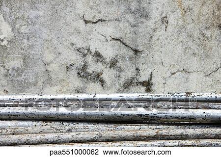Metal piping stacked against wall View Large Photo Image Stock Image - Metal piping stacked against wall. Fotosearch