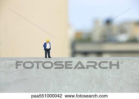 Plastic figurine of construction worker set on ledge View Large Photo Image Stock Image - Plastic figurine of construction worker set on ledge. Fotosearch