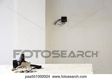 "Safety mask, work gloves on table in unfinished room" View Large Photo Image Picture - "Safety mask, work gloves on table in unfinished room". Fotosearch