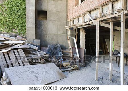 "Scaffolding supporting newly set brick wall, pile of construction waste nearby" View Large Photo Image Stock Image - "Scaffolding supporting newly set brick wall, pile of construction waste nearby". Fotosearch