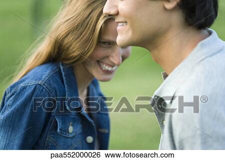 Stock Photograph - "Young couple laughing, cropped". Fotosearch