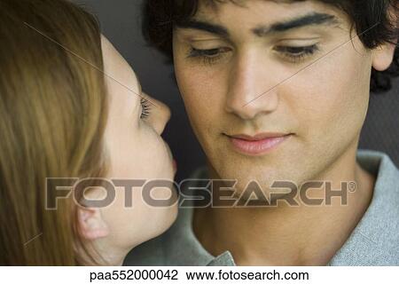 "Young woman leaning in to kiss man, close-up" View Large Photo Image Stock Image - "Young woman leaning in to kiss man, close-up". Fotosearch