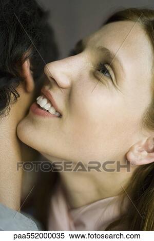 "Young woman whispering in man's ear, smiling, close-up" View Large Photo Image Stock Photography - "Young woman whispering in man's ear, smiling, close-up". Fotosearch