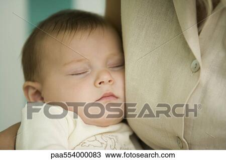 Baby sleeping against mother's chest, close-up View Large Photo Image Stock Image - Baby sleeping against mother's chest, close-up. Fotosearch
