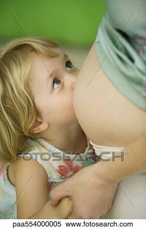 Little girl leaning against pregnant mother's belly View Large Photo Image Stock Photography - Little girl leaning against pregnant mother's belly. Fotosearch