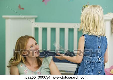 Little girl playing with mother in bedroom View Large Photo Image Picture - Little girl playing with mother in bedroom. Fotosearch