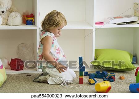 Little girl playing with plastic blocks View Large Photo Image Stock Image - Little girl playing with plastic blocks. Fotosearch