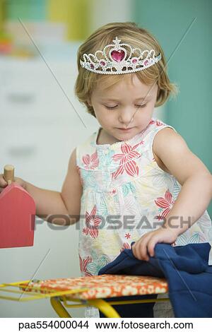 Picture - Little girl pretending to iron. Fotosearch