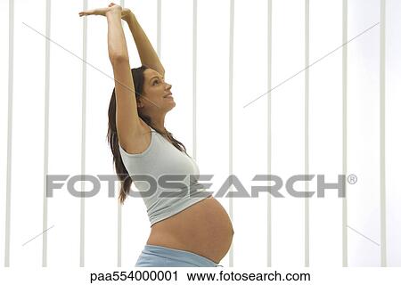 Pregnant woman doing stretches View Large Photo Image Stock Image - Pregnant woman doing stretches. Fotosearch
