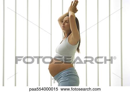 Stock Photography - Pregnant woman doing yoga. Fotosearch