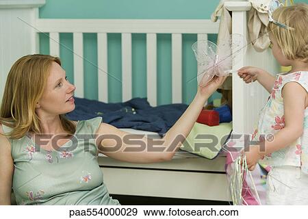 Woman playing with daughter in nursery View Large Photo Image Stock Photo - Woman playing with daughter in nursery. Fotosearch