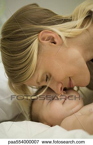 Young mother nuzzling sleeping baby View Large Photo Image Stock Photo - Young mother nuzzling sleeping baby. Fotosearch