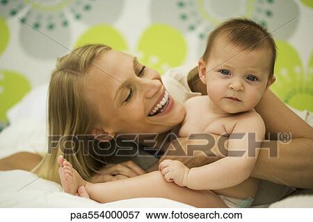 Young mother with baby View Large Photo Image Stock Photo - Young mother with baby. Fotosearch