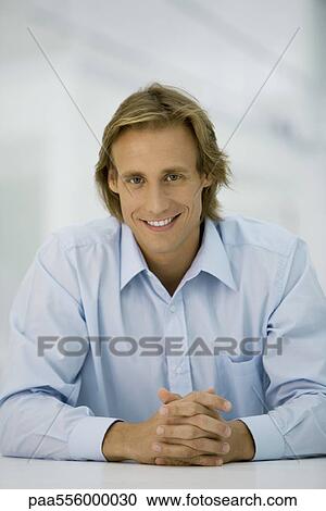 Blond man with clasped hands looking at camera, portrait View Large Photo Image Stock Image - Blond man with clasped hands looking at camera, portrait. Fotosearch