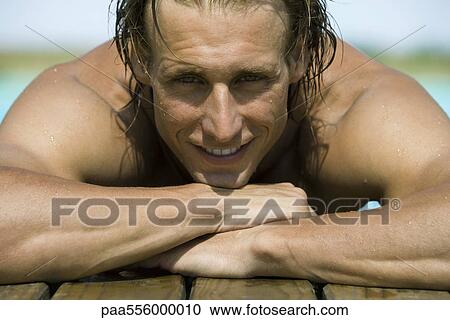 Man on deck with head resting on arms, smiling at camera View Large Photo Image Stock Image - Man on deck with head resting on arms, smiling at camera. Fotosearch