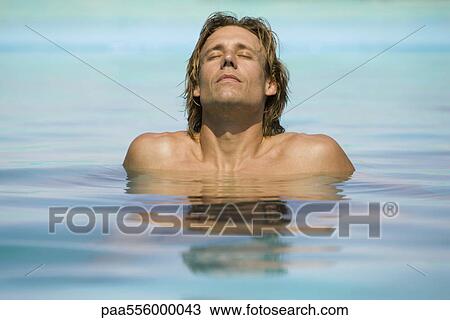 Man relaxing in shallow end of pool View Large Photo Image Stock Image - Man relaxing in shallow end of pool. Fotosearch