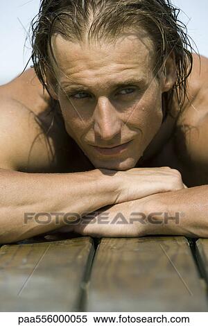 Man resting head on arms on side of pool View Large Photo Image Stock Photography - Man resting head on arms on side of pool. Fotosearch