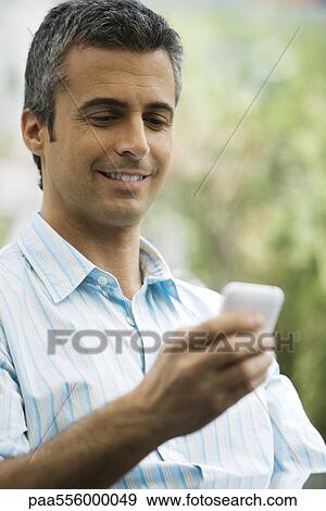 Man text messaging with cell phone View Large Photo Image Stock Photo - Man text messaging with cell phone. Fotosearch
