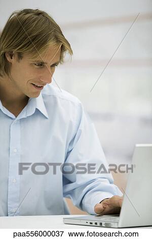 Man using laptop computer View Large Photo Image Stock Photo - Man using laptop computer. Fotosearch